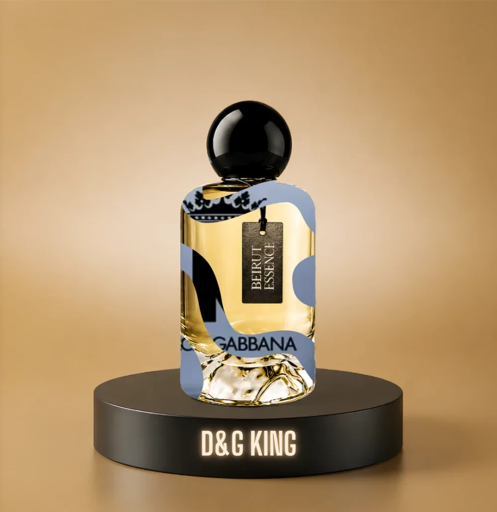 BeirutEssence fragrance inspired by D&G King, photographed on a dark pedestal with a warm gold background