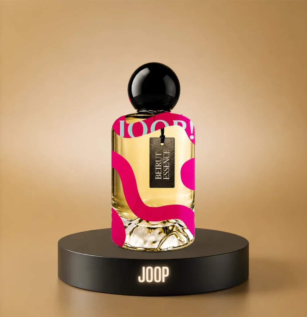 BeirutEssence fragrance inspired by Joop, photographed on a dark pedestal with a warm gold background