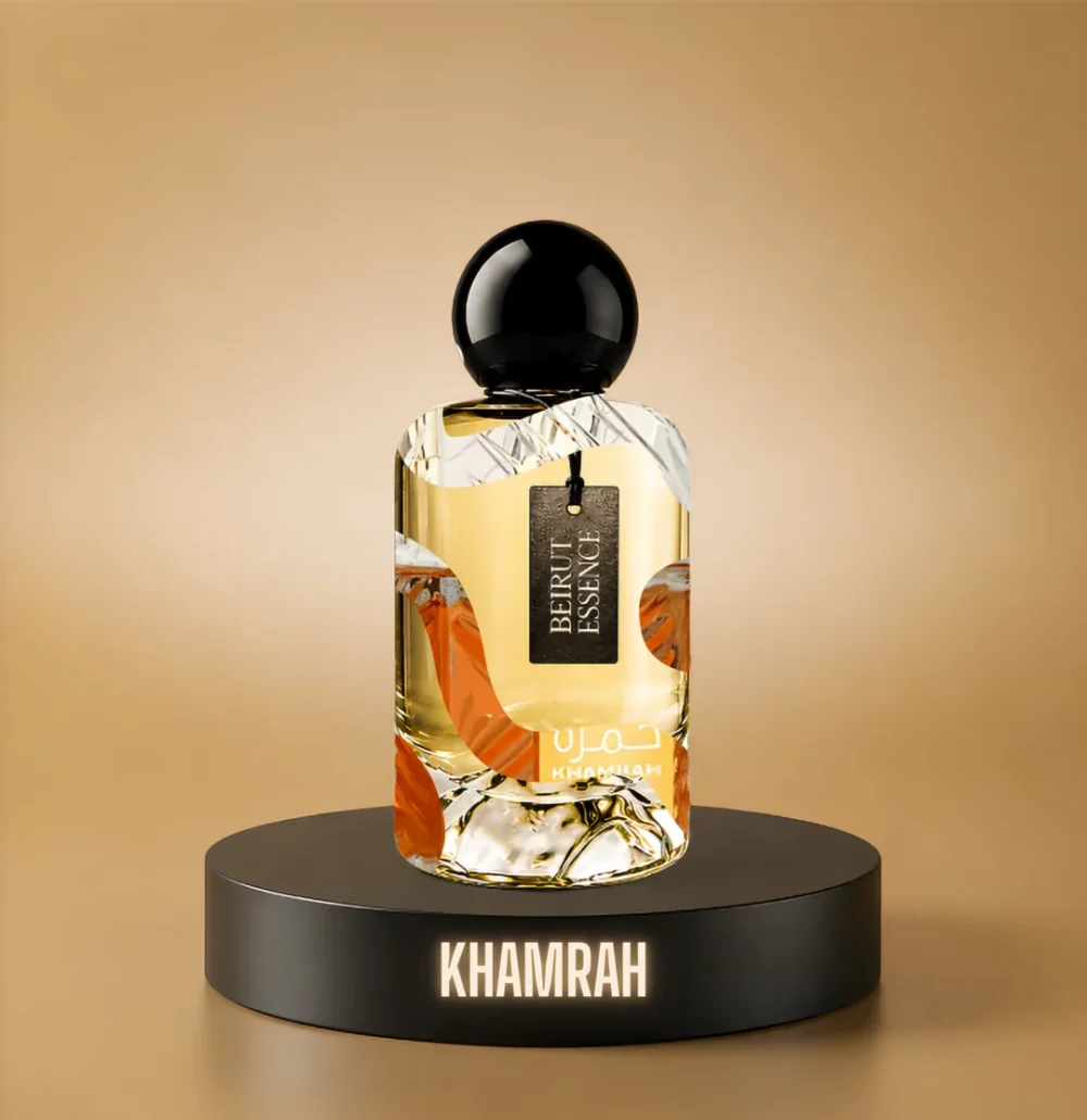 BeirutEssence fragrance inspired by Khamrah, photographed on a dark pedestal with a warm gold background