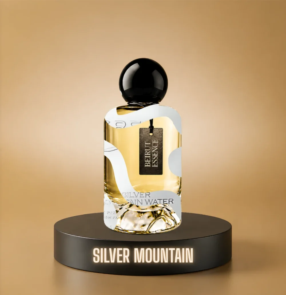 BeirutEssence fragrance inspired by Silver Mountain, photographed on a dark pedestal with a warm gold background